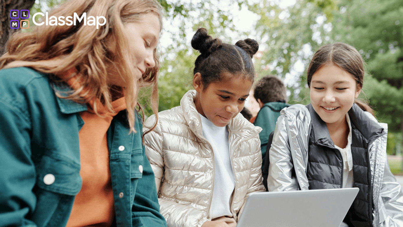 Students using a laptop outside of a classroom
